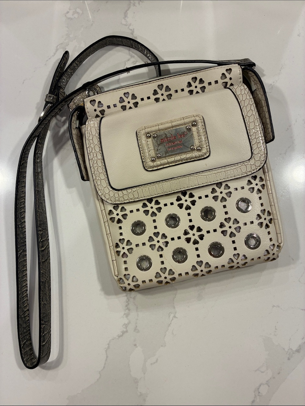 Nicole Lee Cream Laser-Cut Crossbody with Silver Grommets